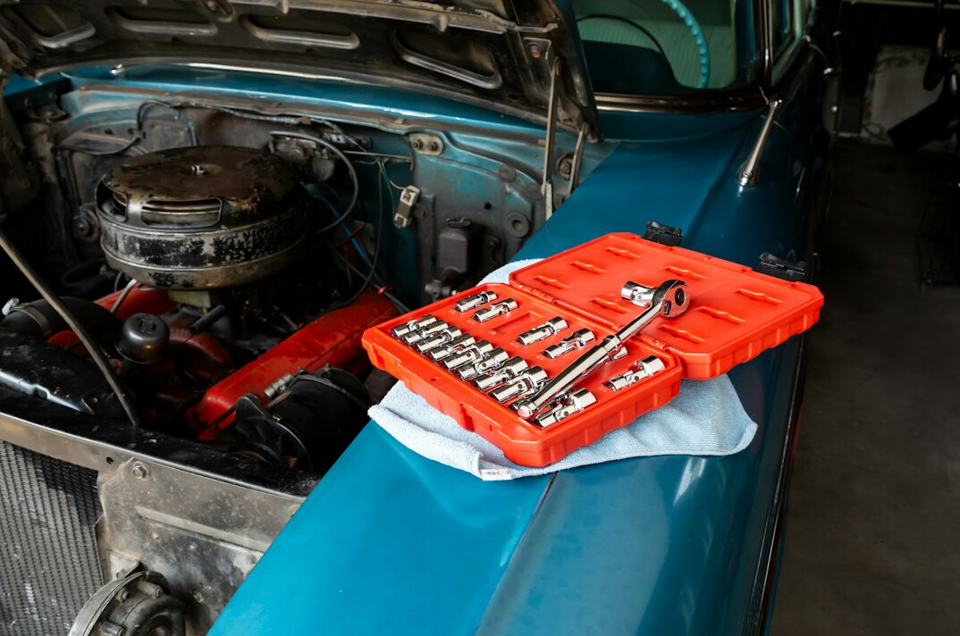 Mechanic working on a car engine in a workshop