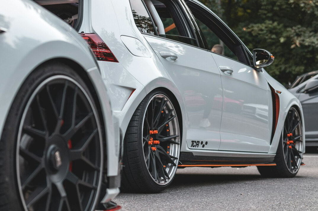 Compact car with custom alloy wheels parked outdoors